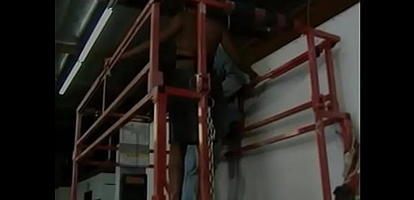 Hot ebony chick with perky tits gives a blowjob to a white guy in a warehouse